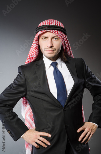 Arab businesssman against grey background photo