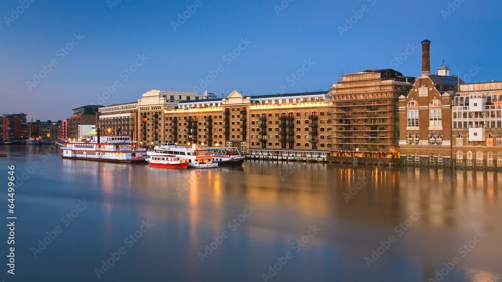 Historic buildings and boats along Thames in London.