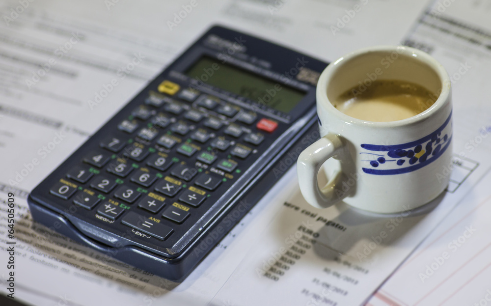Utility bills, coffee and calculator Utility bills, coffee and calculator