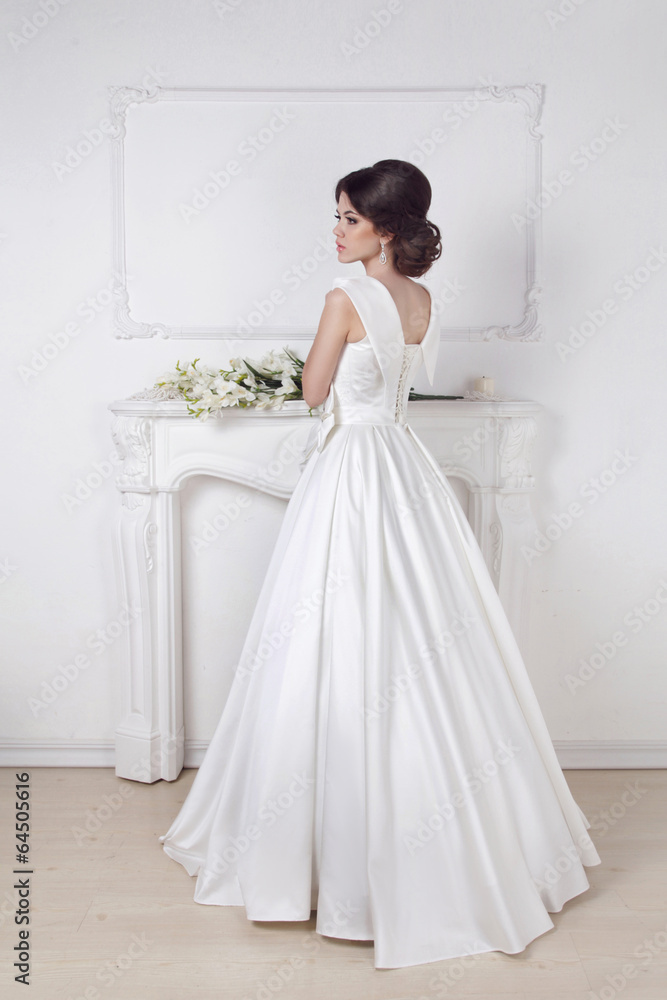 Beautiful charming bride in wedding luxurious dress posing again Beautiful charming bride in wedding luxurious dress posing again