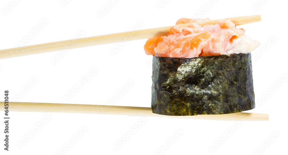 Isolated sushi gunkan in chopsticks. Macro. Isolated sushi gunkan in chopsticks. Macro.
