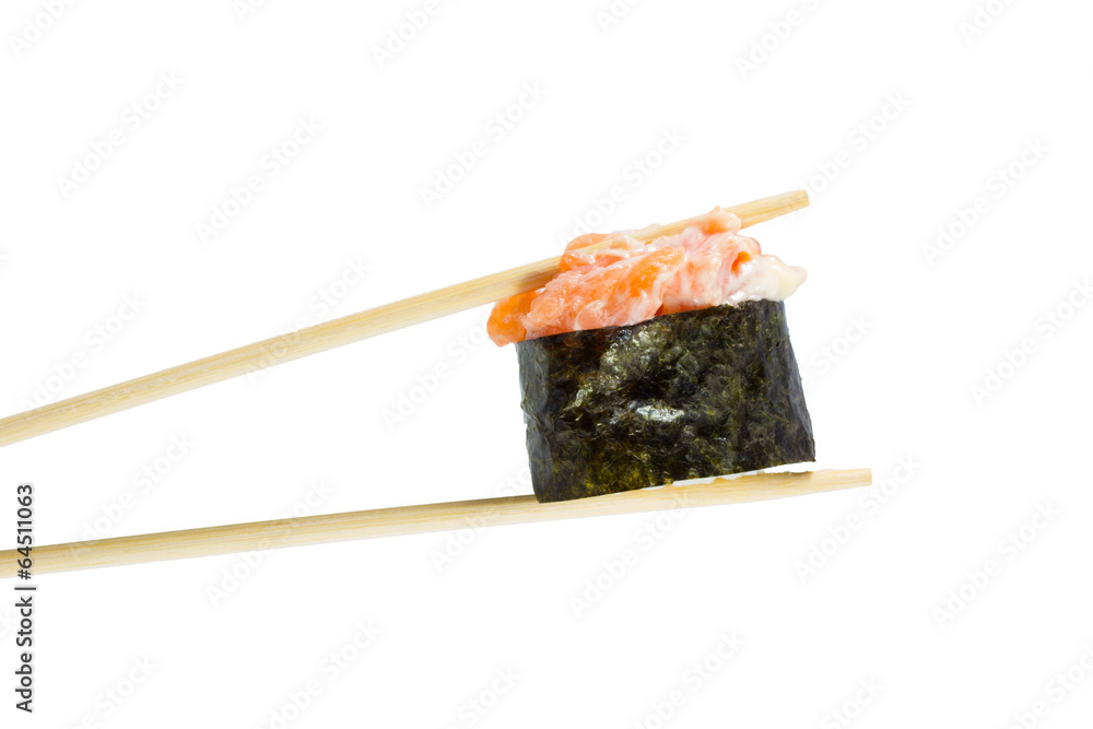 Isolated sushi gunkan in chopsticks. Macro.