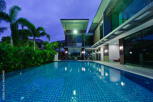Modern house with swimming pool at night © det-anan sunonethong