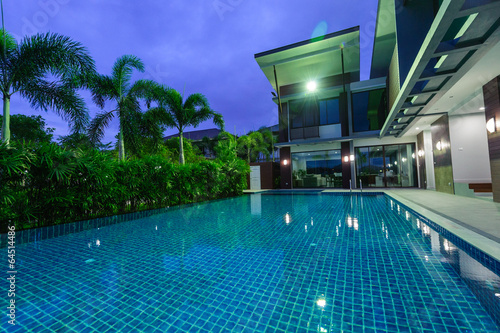 Modern house with swimming pool at night