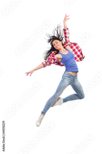 Happy woman jumping with arms outstretched.