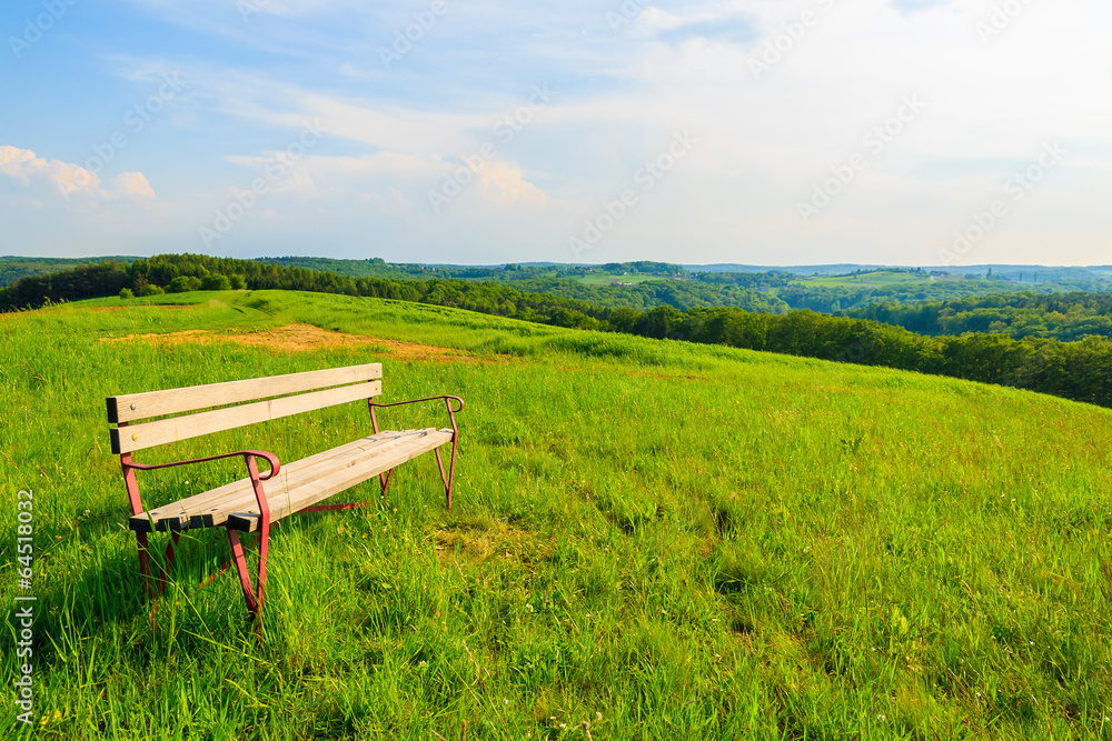 Bench on meadow in countryside landscape, Austria Bench on meadow in countryside landscape, Austria
