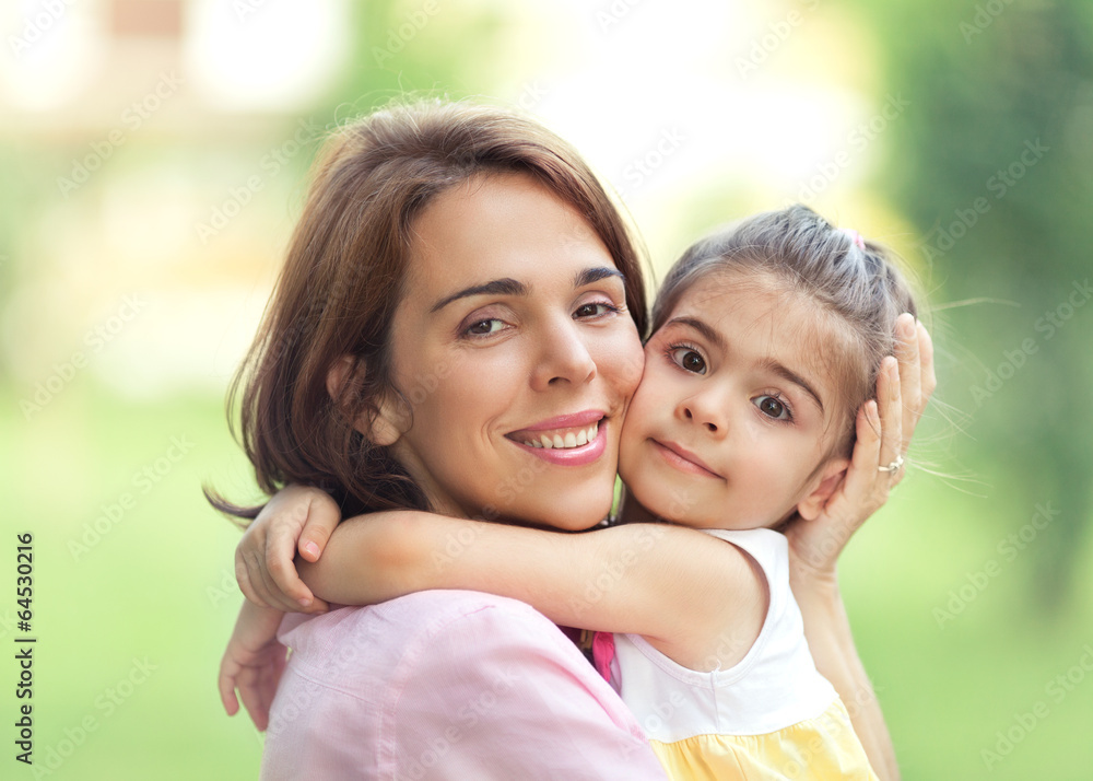 Mother and cute little daughter portrait outdoors. Mother and cute little daughter portrait outdoors.