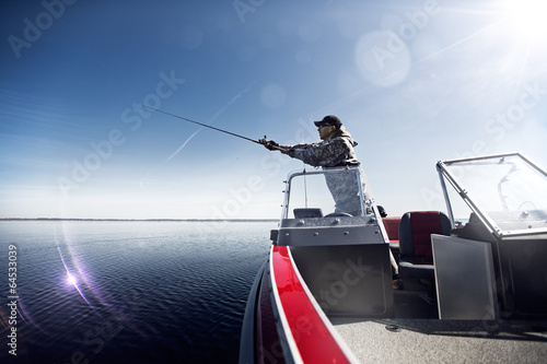 Slika na platnu Men is fishing at the boat