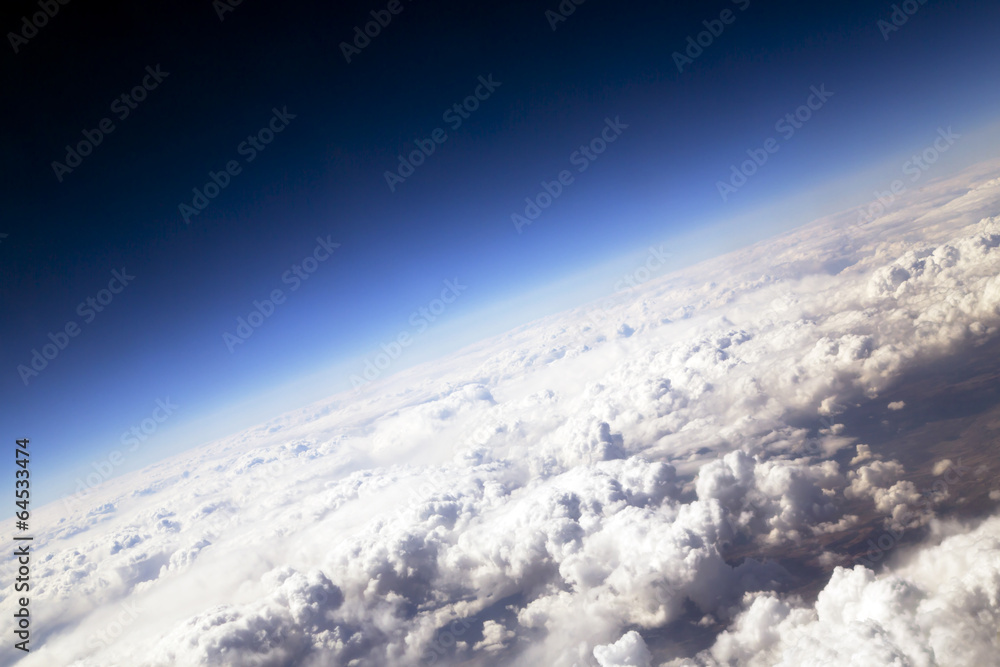 Blue sky and puffy clouds with the brightly expressed atmosphere