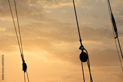 Afterglow rope silhouettes. Romantic shipping adventure trip.