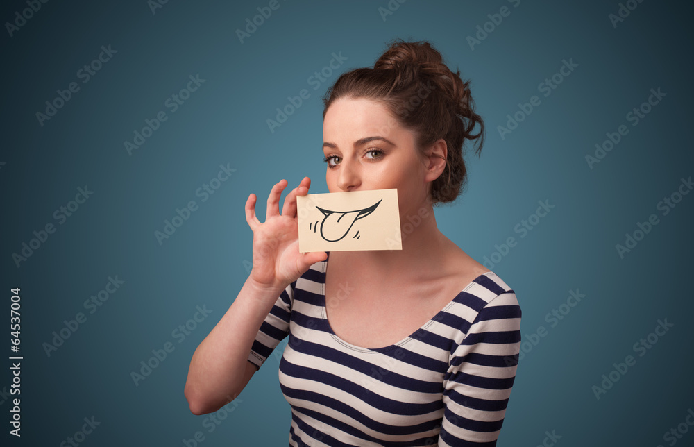 Pretty young girl holding white card with smile drawing Pretty young girl holding white card with smile drawing
