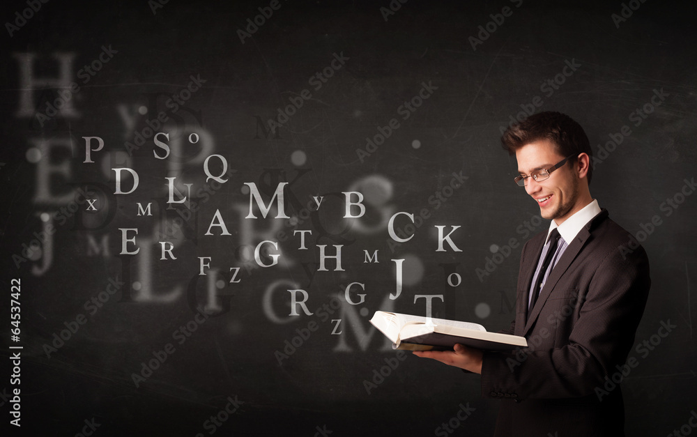 Young man reading a book with alphabet letters Young man reading a book with alphabet letters