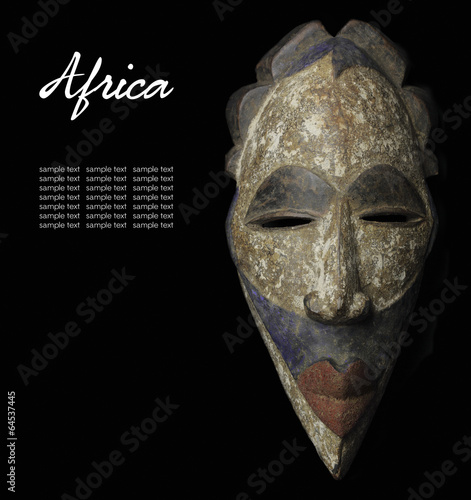 African mask over black background