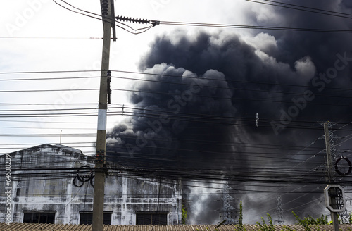 black smoke from fire burning house © nbriam