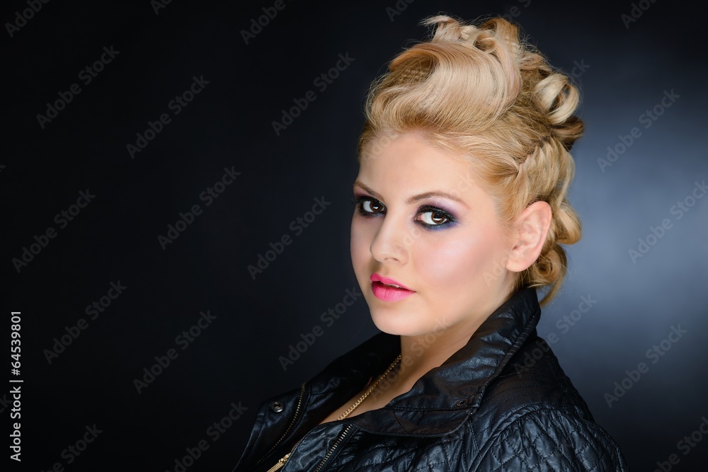 Young blonde woman with make-up and black leather jacket