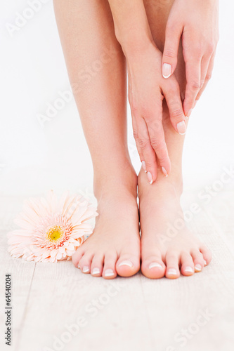 Taking care of her feet. © gstockstudio