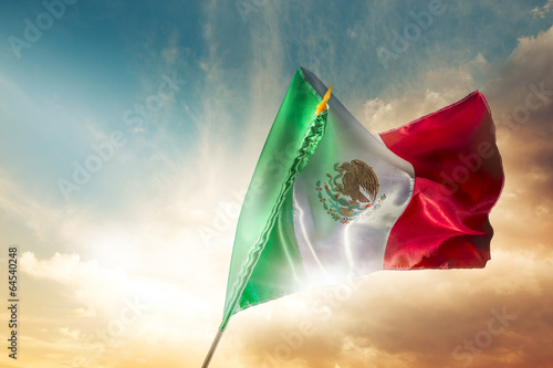 Fotografia Mexican flag against a bright sky, independence day, cinco de ma