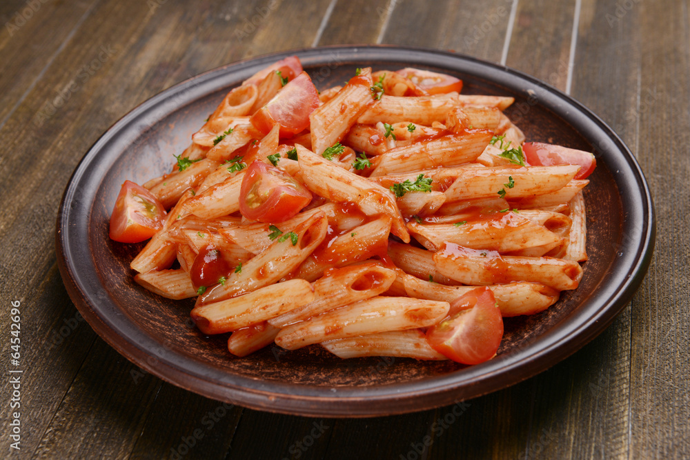 Pasta with tomato sauce on plate on table close-up Pasta with tomato sauce on plate on table close-up