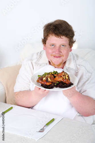 Tasty lunch for fat man  on home interior background