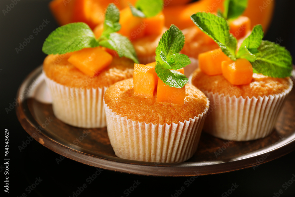 Tasty pumpkin muffins on dark background Tasty pumpkin muffins on dark background