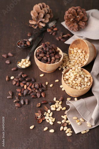 Cedar pine nuts in bowls, on wooden table