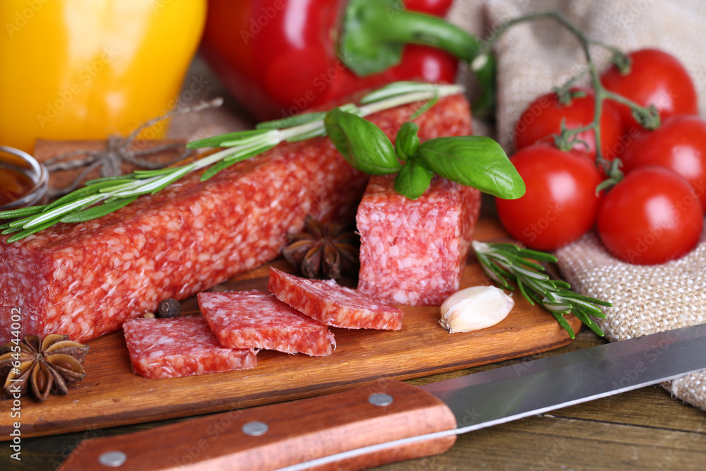 Tasty salami sausage and spices on wooden background Tasty salami sausage and spices on wooden background