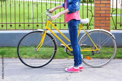 Young woman with bicycle outdoors