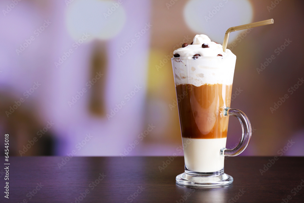 Glass of coffee on color wooden table, on dark background Glass of coffee on color wooden table, on dark background