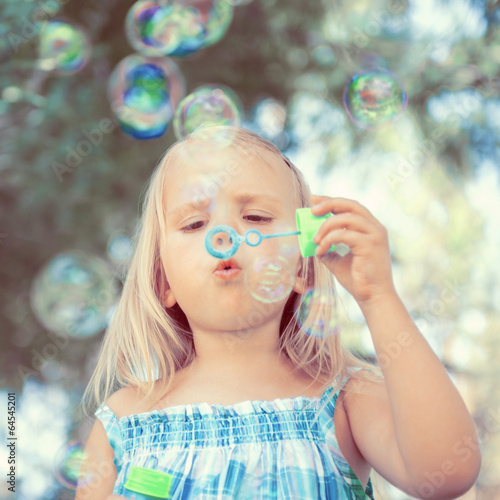 little girl with soap bubbles
