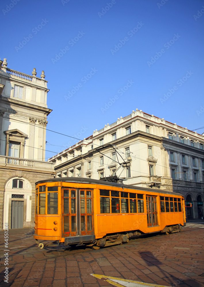 Old orange tram near La Scala theater in Milan, italy