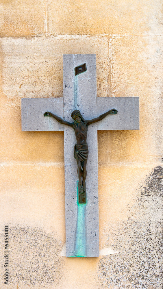 Tombstone with crucifix on a cemetery in France.