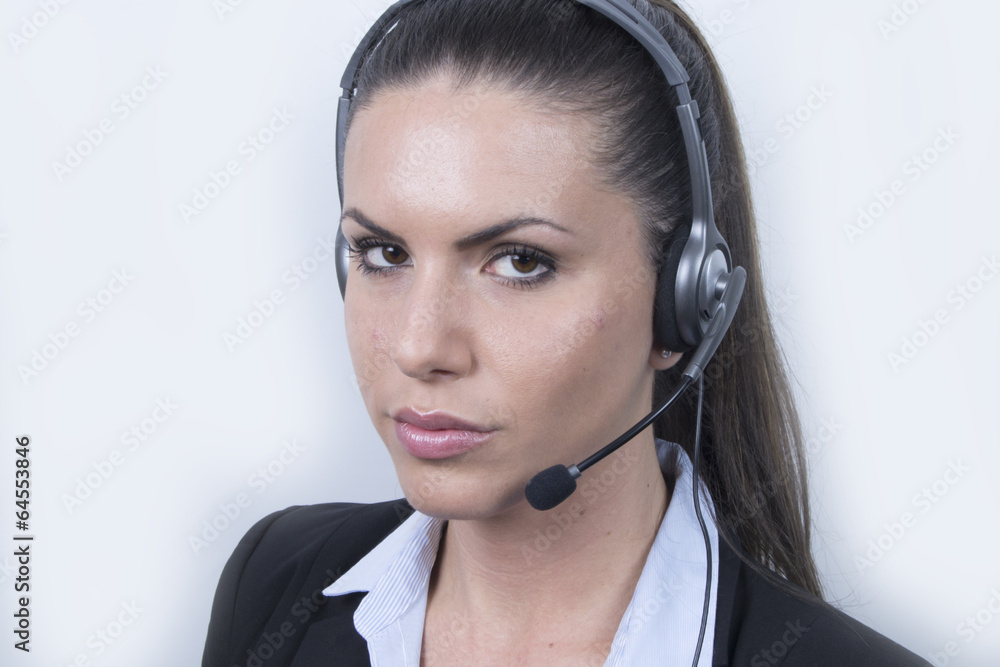 Serious Business woman with headphones (headset, office) Serious Business woman with headphones (headset, office)