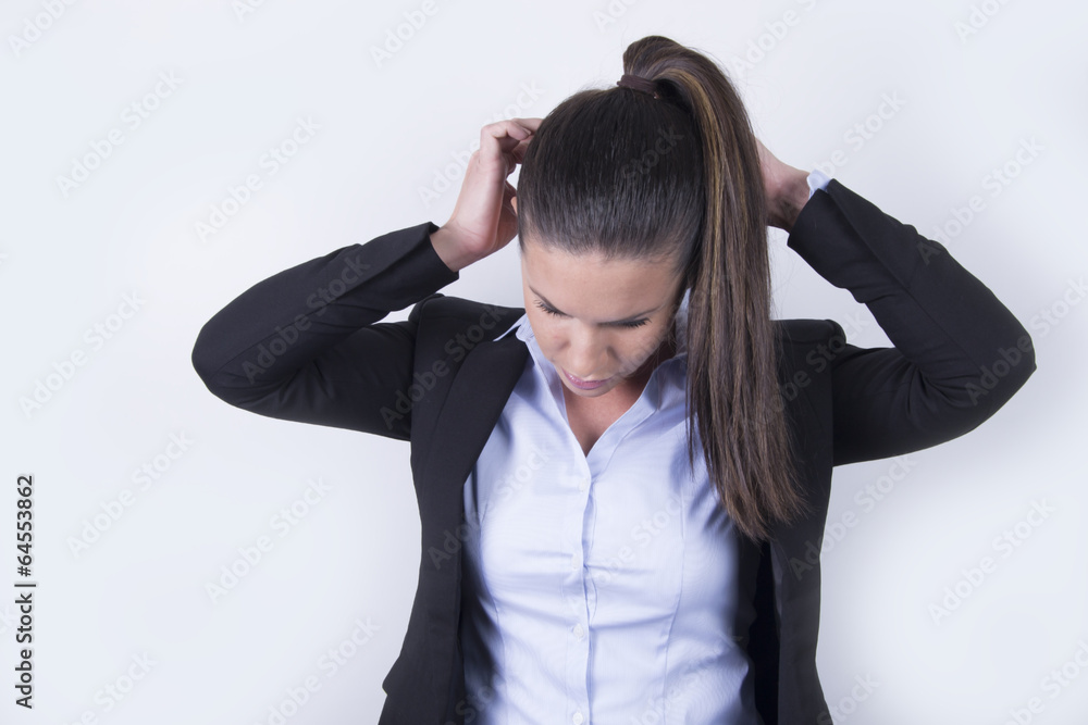 Young business woman fixing her hair (office) Young business woman fixing her hair (office)