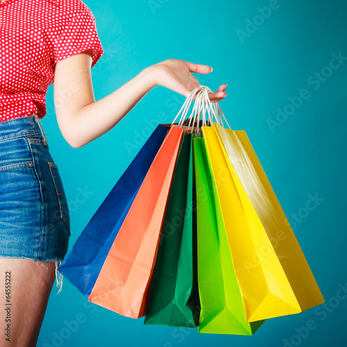 Colorful shopping bags in female hand. Sale retail