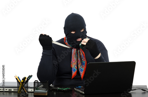 Foto Robber in balaclava with knife talking on the cell phone