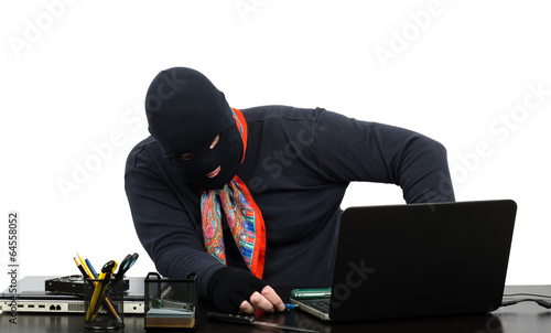 фотографія Thief inserting usb flash memory into laptop