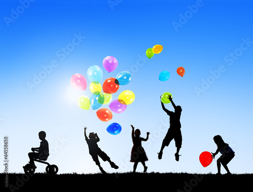 Silhouettes of Children Playing Balloons Outdoors
