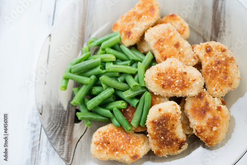 Chicken nuggets with beans, view from above, horizontal shot