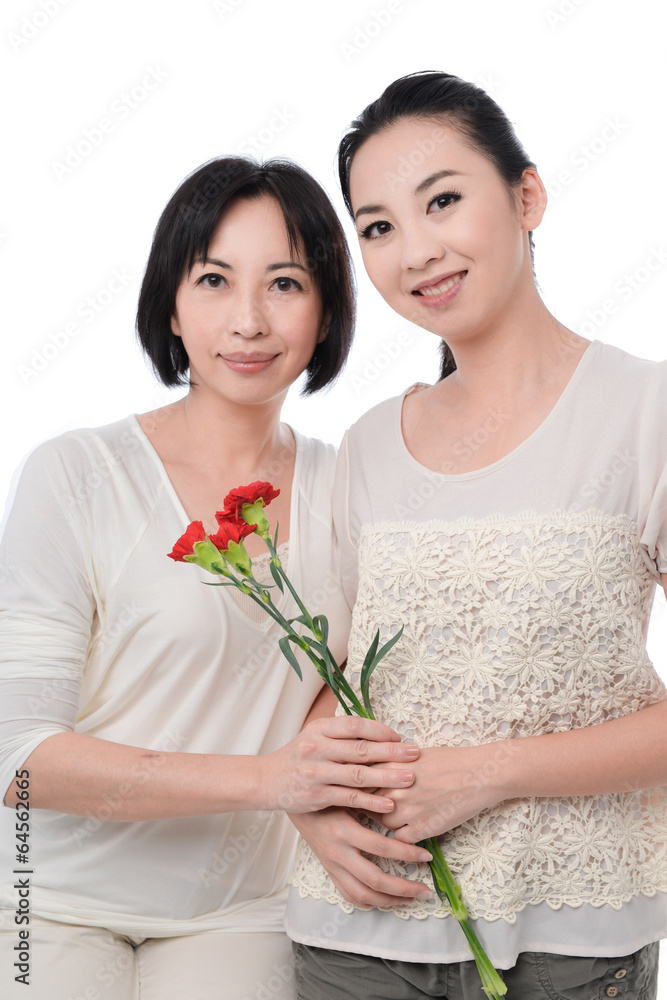 Asian woman giving carnation flower to her mother Asian woman giving carnation flower to her mother