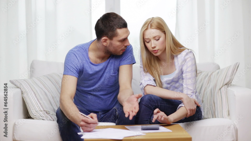busy couple with papers and calculator at home busy couple with papers and calculator at home