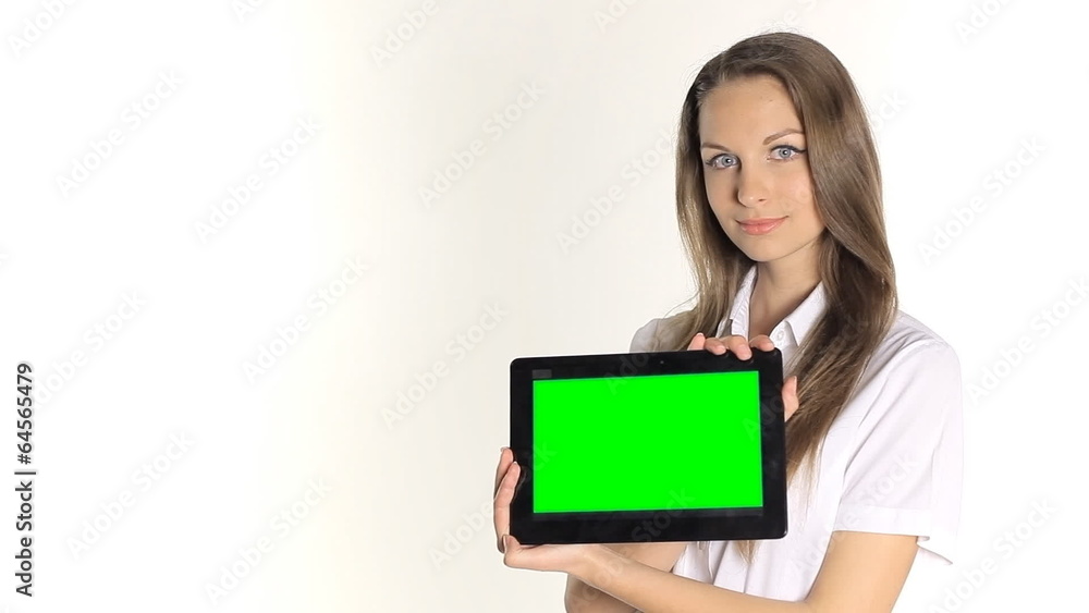 Beautiful girl shows information from the tablet on a white Beautiful girl shows information from the tablet on a white