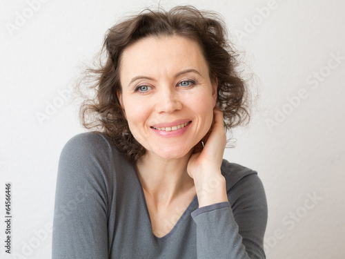 Happy woman with attractive smile thinking about