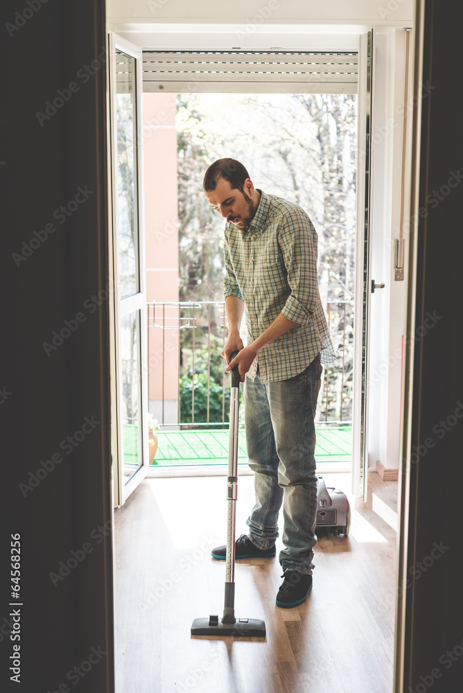 handsome stylish man using hoover handsome stylish man using hoover