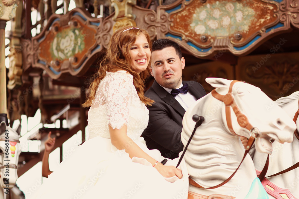 Bride and groom in a carousel