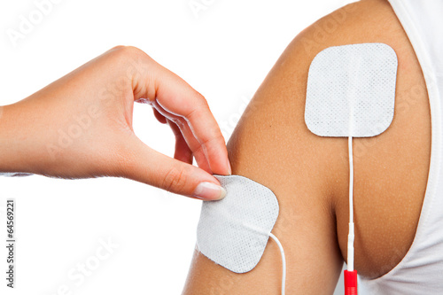 electrodes of tens device on shoulder, tens therapy, nerve stimu