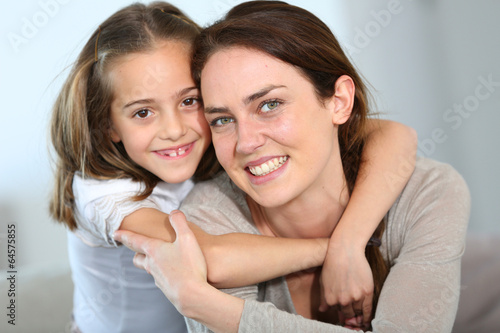 Portrait of mother and daughter in tender moment