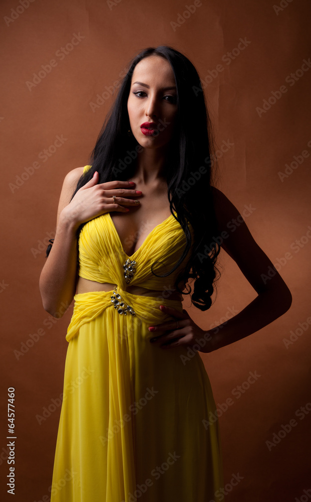 Fototapeta premium portrait of a beautiful girl in a yellow dress