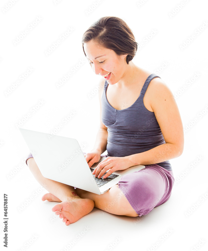 Young woman sitting on floor using laptop Young woman sitting on floor using laptop