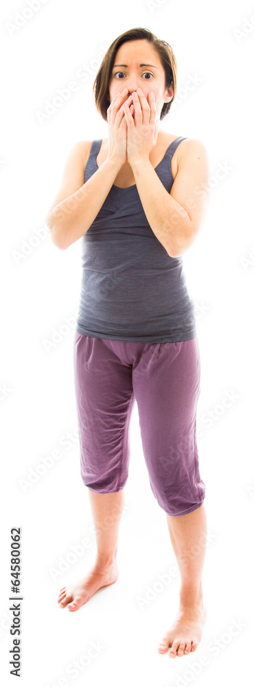 Young woman with hand over her mouth and shock Young woman with hand over her mouth and shock