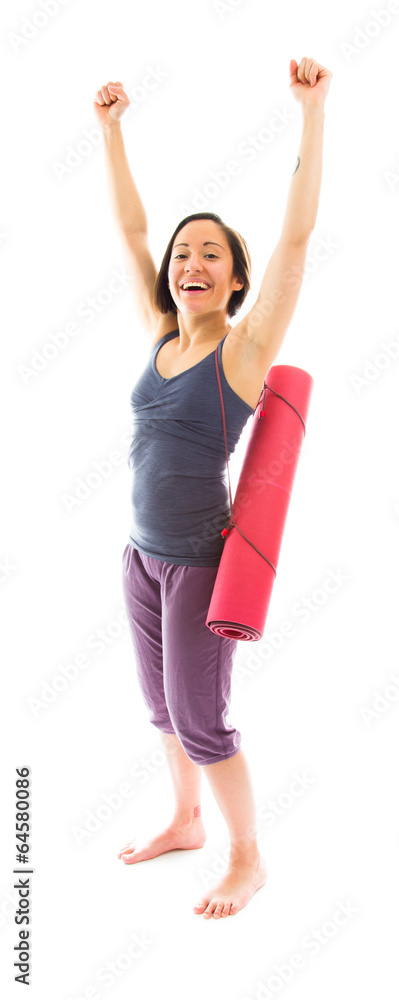 Young woman carrying exercise mat celebrating success Young woman carrying exercise mat celebrating success